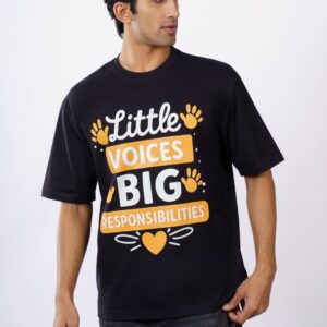 South Asian man in oversized black T-shirt featuring a positive message, shot indoors.